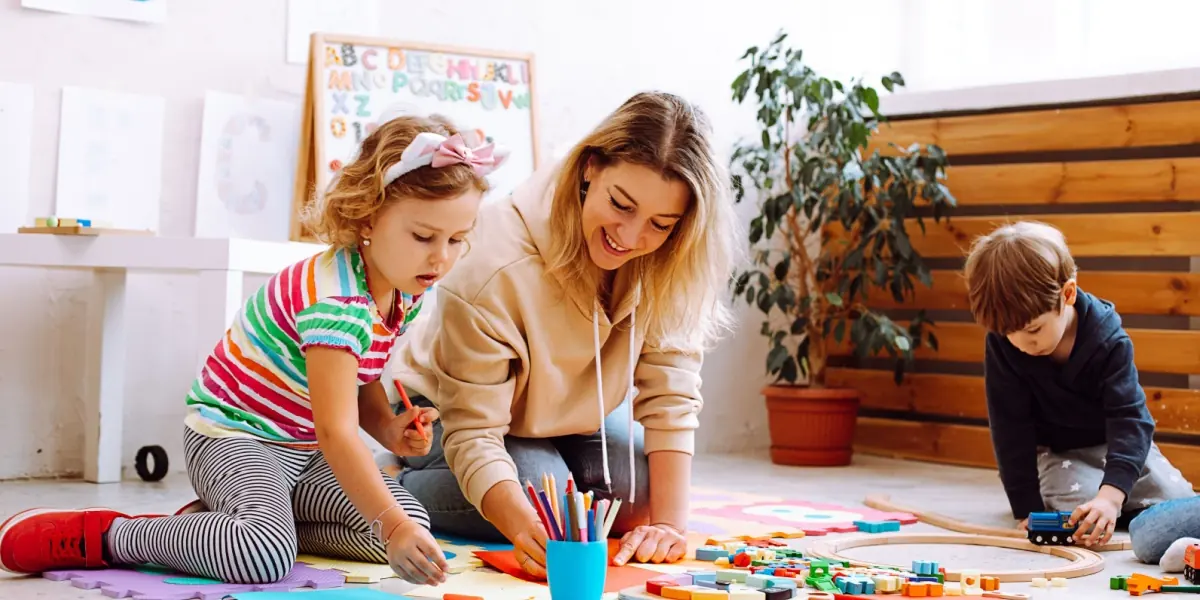 An adult and children spend time together at home.