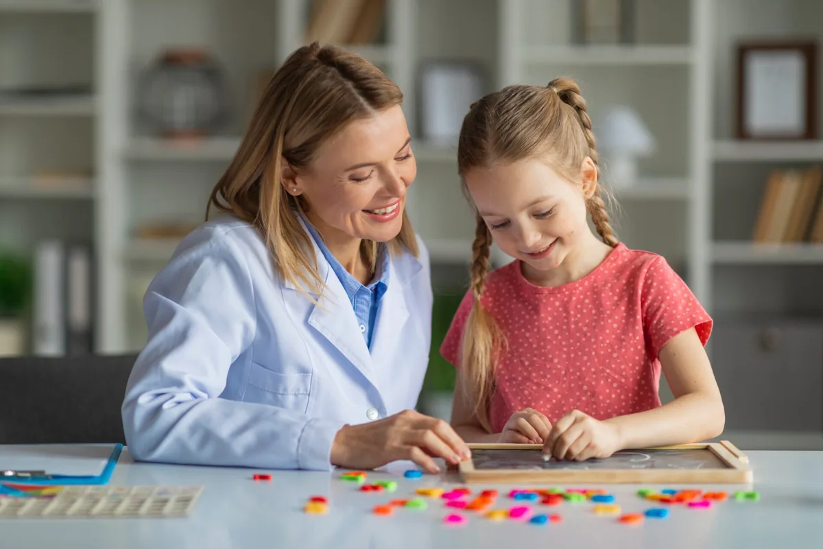 An adult and child work together with colorful learning materials.