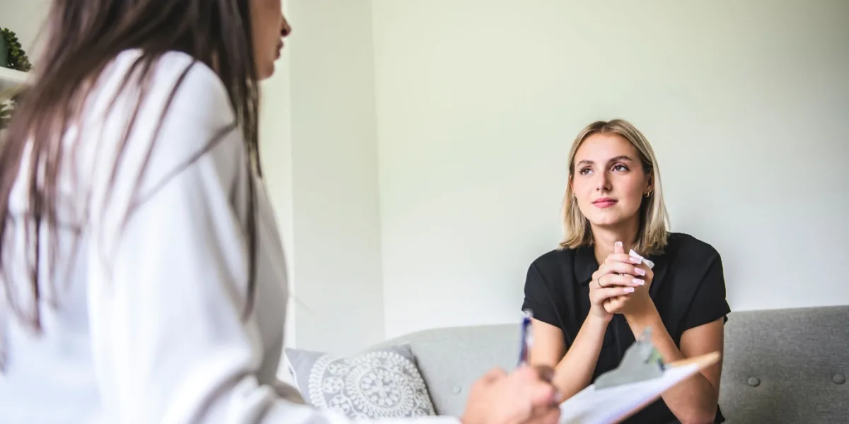 A woman discusses her concerns with a healthcare professional.