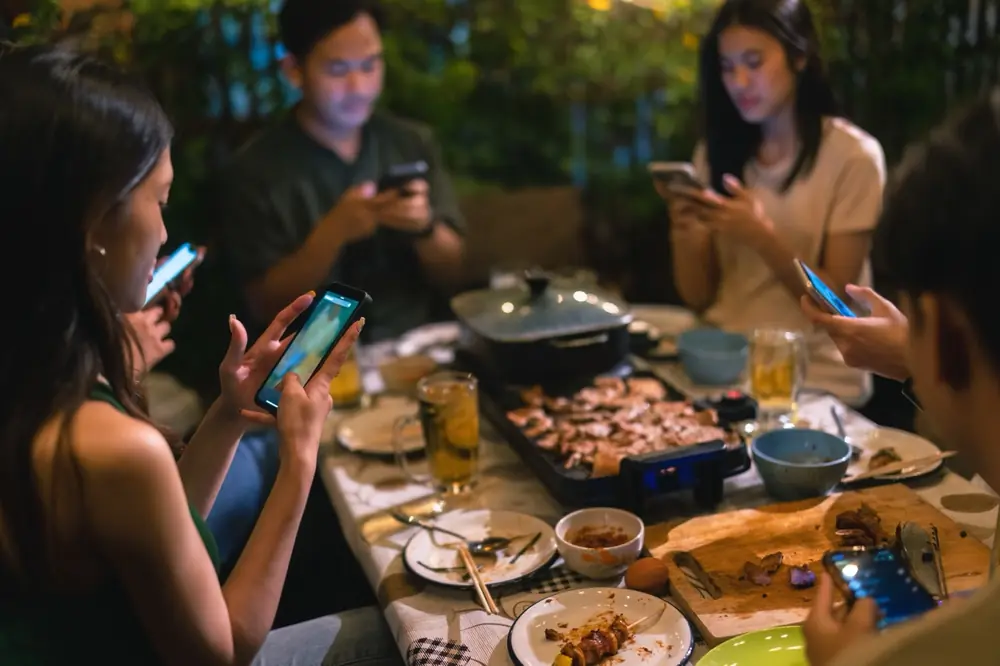Friends share a meal together around a table.