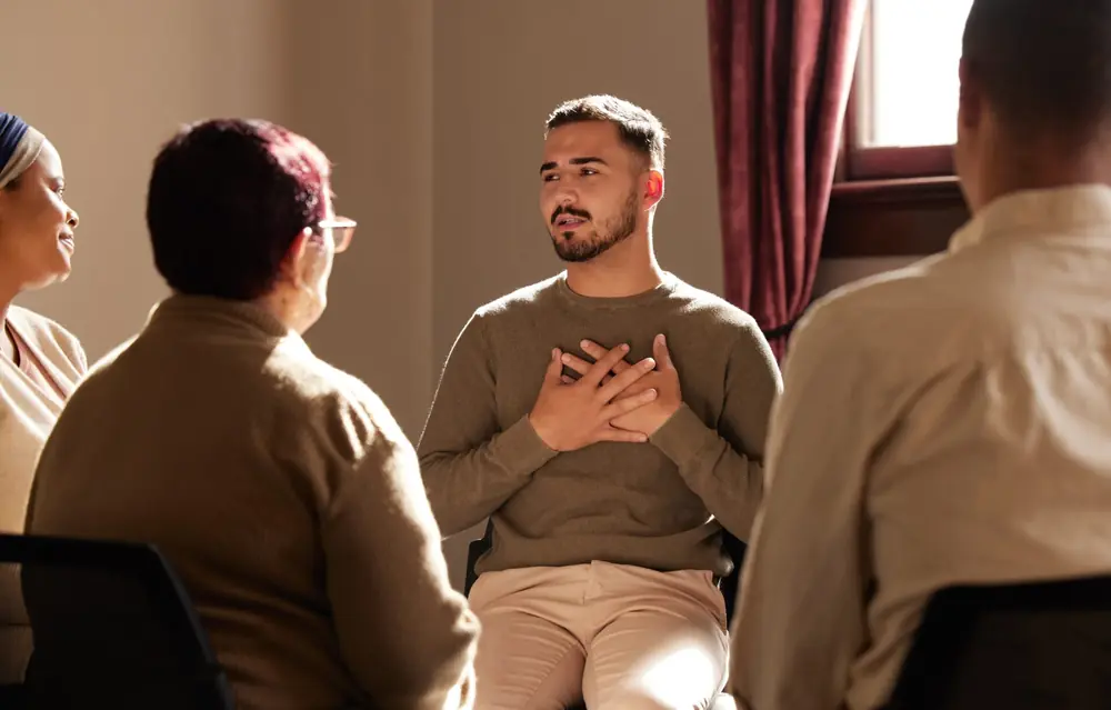 A man speaks during a small group conversation.