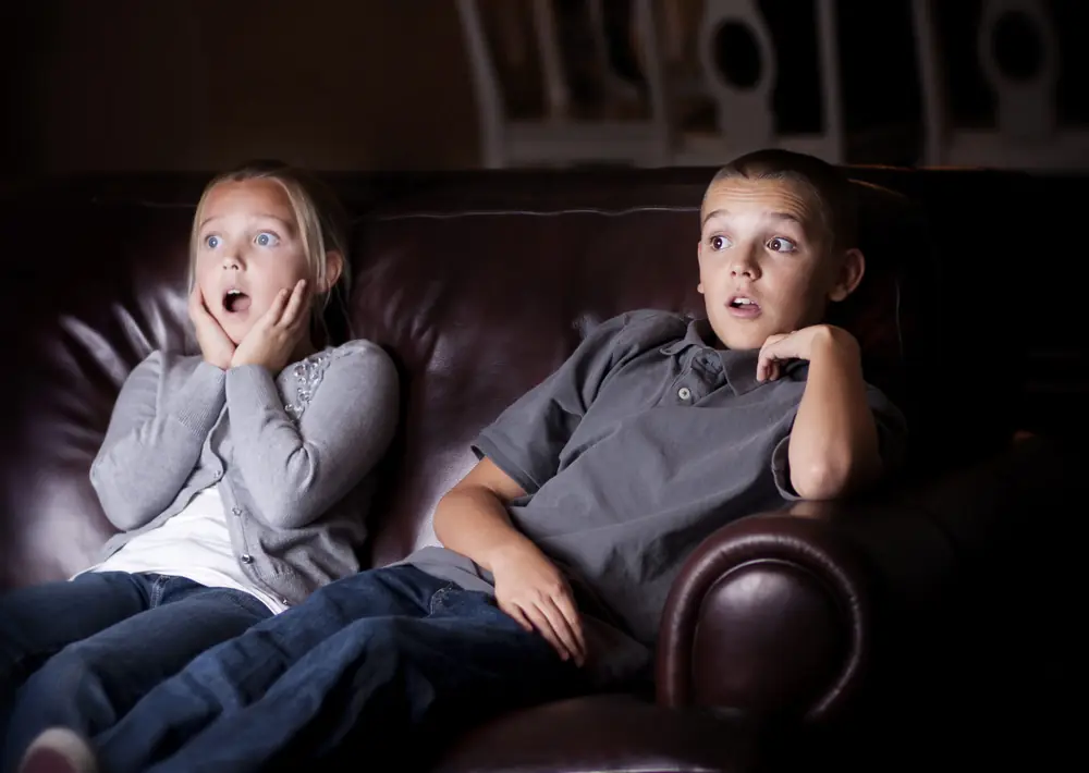Children watch a television screen together.