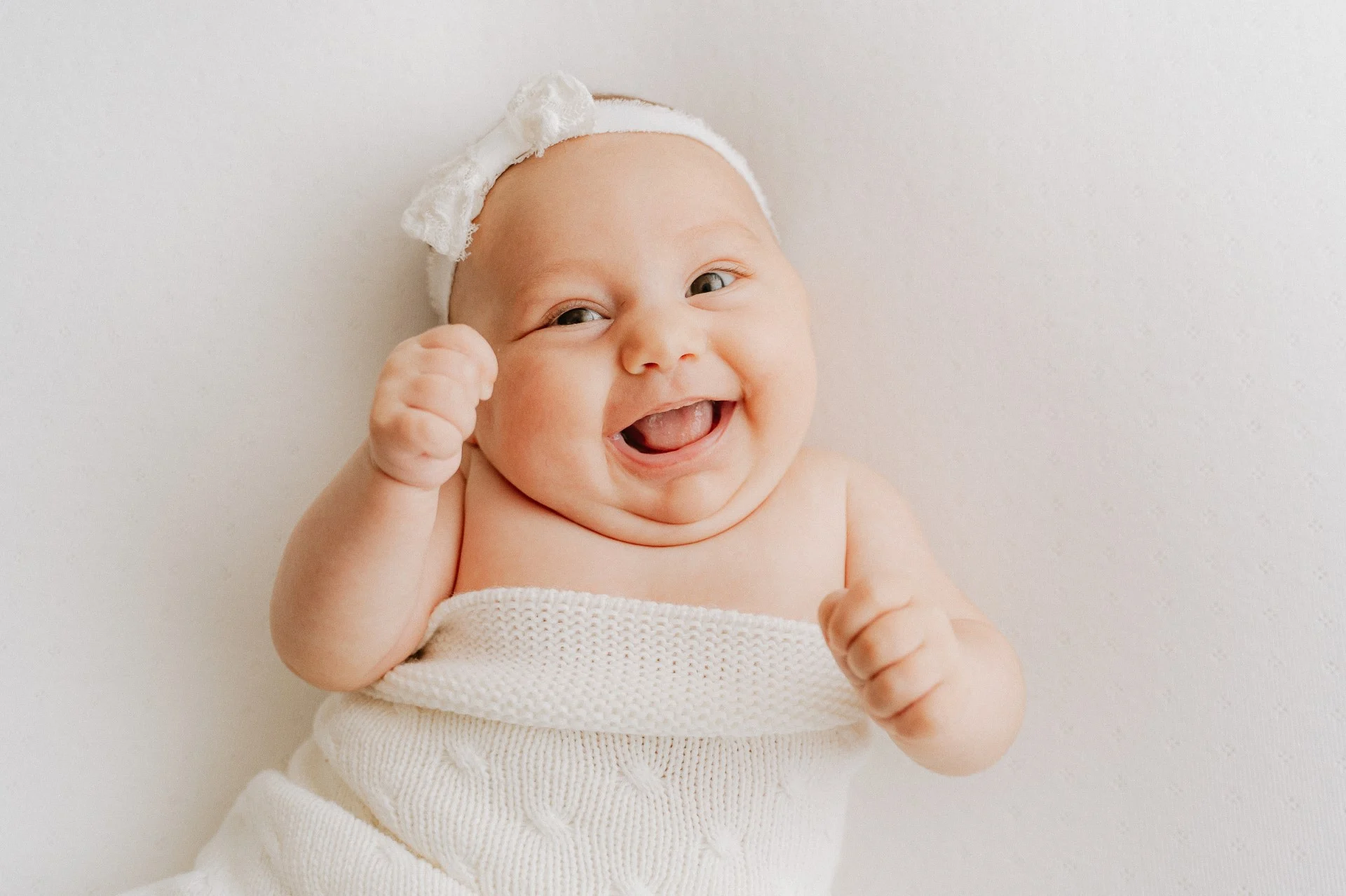 a baby with a white hat